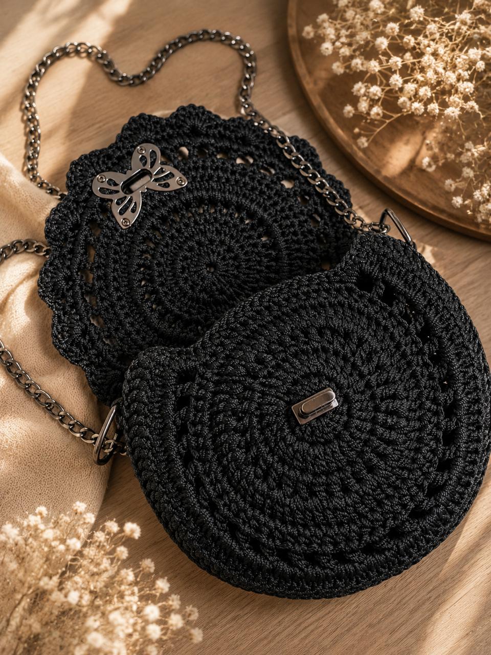 Close view of two black circular crochet bags showing stitch details and metal hardware