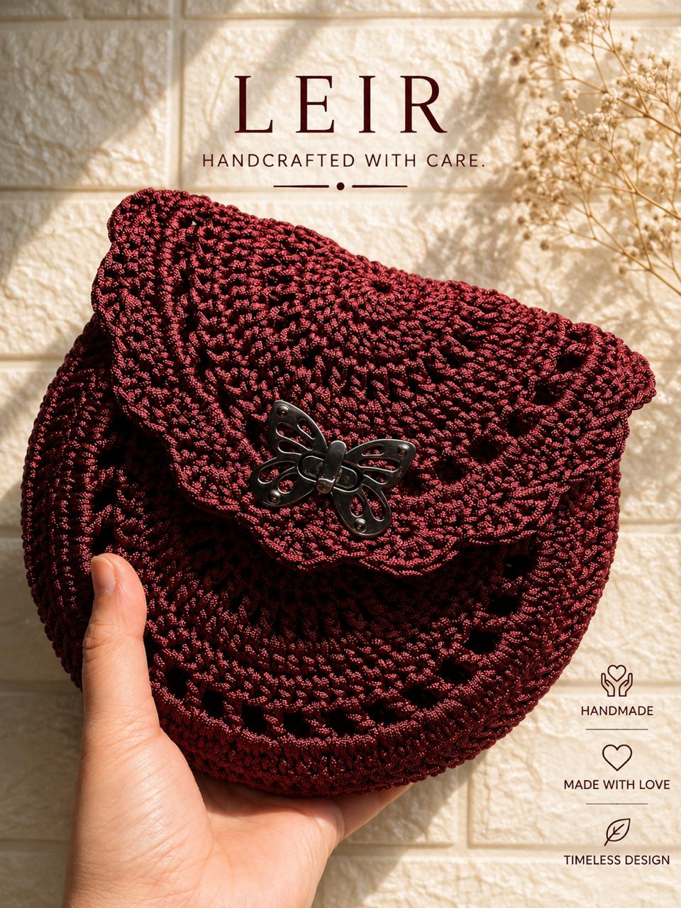 Burgundy circular crochet butterfly bag held by hand
